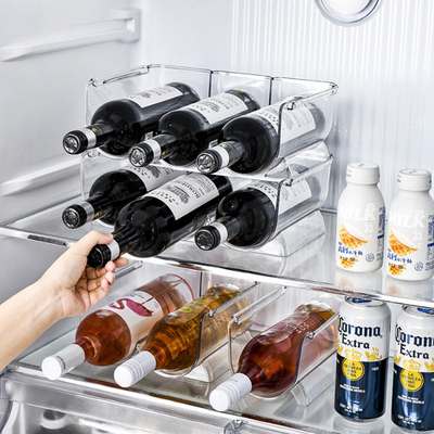 O suporte de garrafa de água plástico do vinho dos escaninhos de armazenamento do refrigerador está empilhável