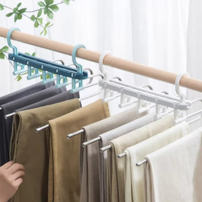 Espaço dos eletrodomésticos que salvar o gancho de dobramento plástico que seca cremalheiras para a roupa