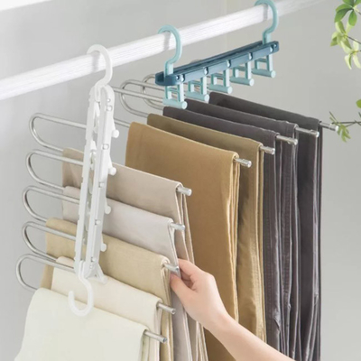 Espaço dos eletrodomésticos que salvar o gancho de dobramento plástico que seca cremalheiras para a roupa
